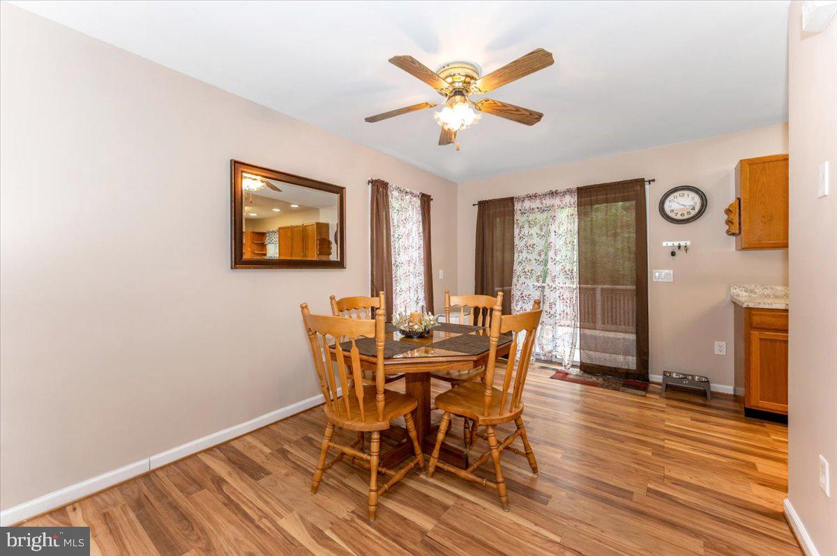 8109 Beverly Road Severn, MD 21144 - Photo 8 of 43 a view of a dining room with furniture and wooden floor
