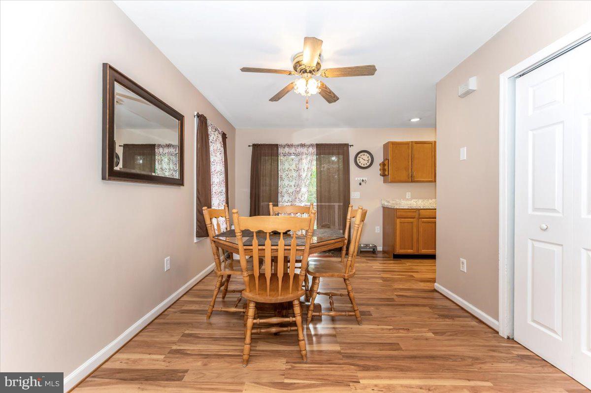 8109 Beverly Road Severn, MD 21144 - Photo 9 of 43 a view of a dining room with furniture and wooden floor