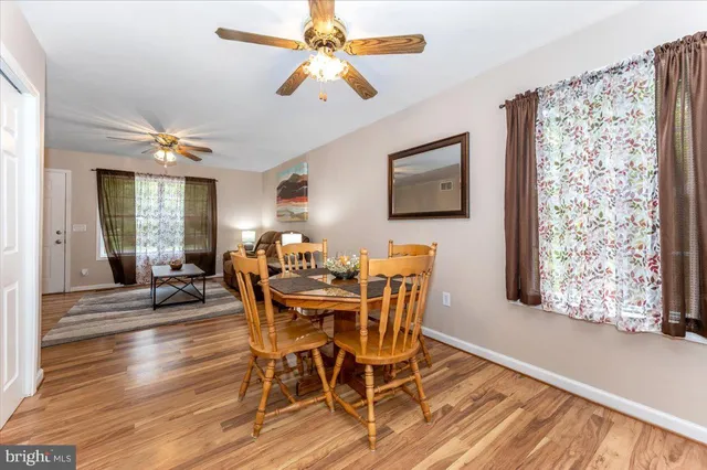 a view of a dining room with furniture and a chandelier