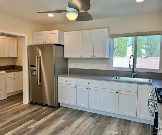 a kitchen with stainless steel appliances a refrigerator sink and cabinets