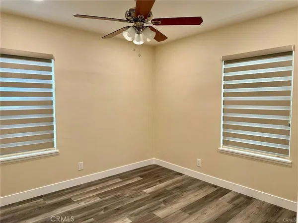 a view of a room with a window and a ceiling fan