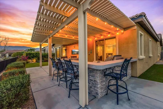 a view of a patio with table and chairs and potted plants