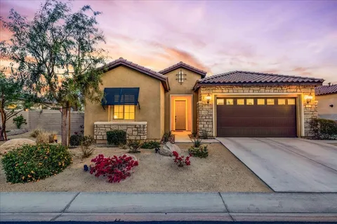 a large kitchen with stainless steel appliances granite countertop a lot of counter space and wooden floors