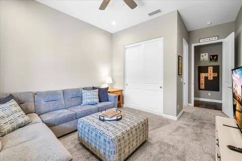 a bathroom with a granite countertop toilet sink and mirror