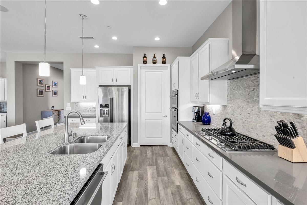 72 Barolo Rancho Mirage, CA 92270 - Photo 32 of 65 a large kitchen with stainless steel appliances granite countertop a lot of counter space and wooden floors