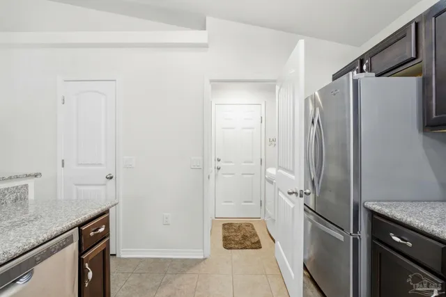 a kitchen with a refrigerator and a sink