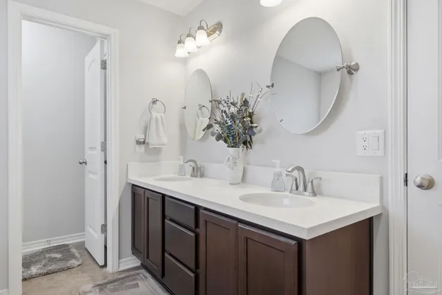 a bathroom with a double vanity sink and a mirror