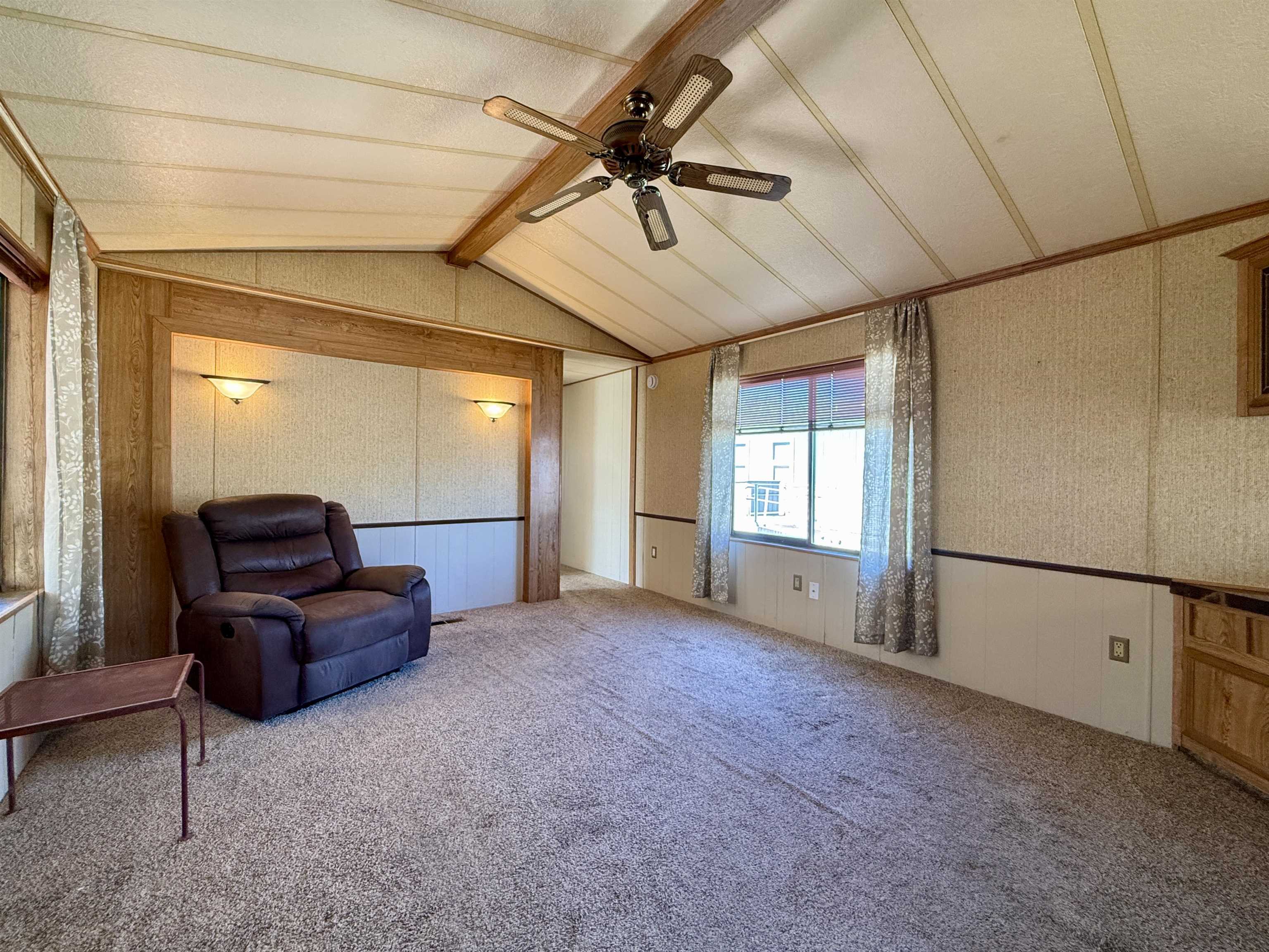 3251 E Road, Unit 33 Clifton, CO 81520 - Photo 12 of 28 a living room with furniture and a window
