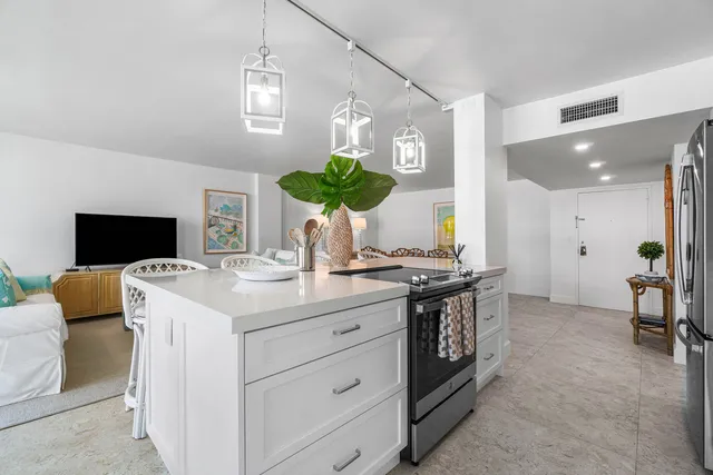 a kitchen with stainless steel appliances a stove a sink and a refrigerator