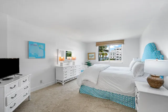 a bedroom with a bed and flat screen tv