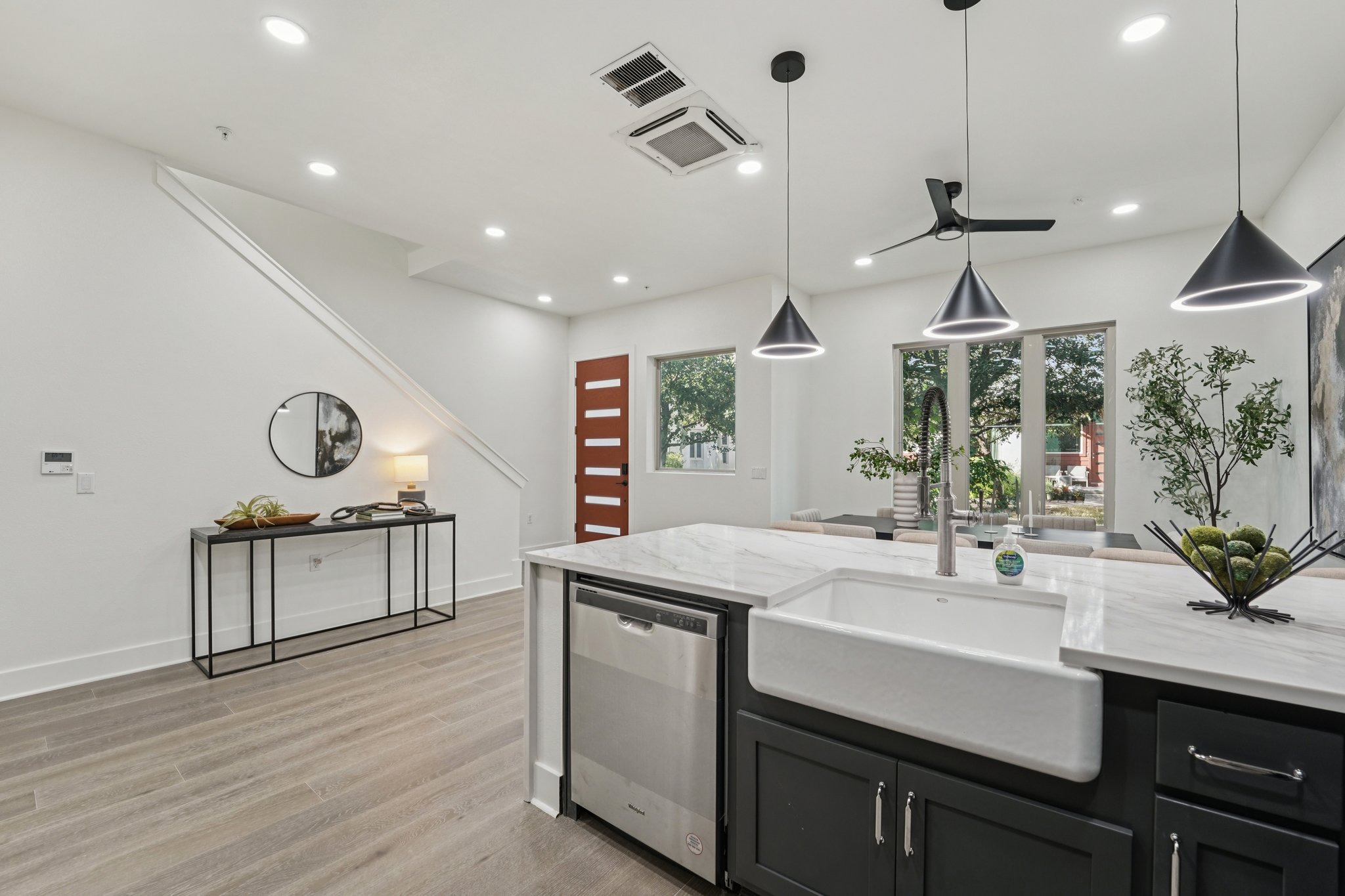 2811 Zach Scott Street Austin, TX 78723 - Photo 11 of 37 Kitchen featuring light stone countertops, pendant lighting, stainless steel dishwasher, light wood finished floors, and recessed lighting