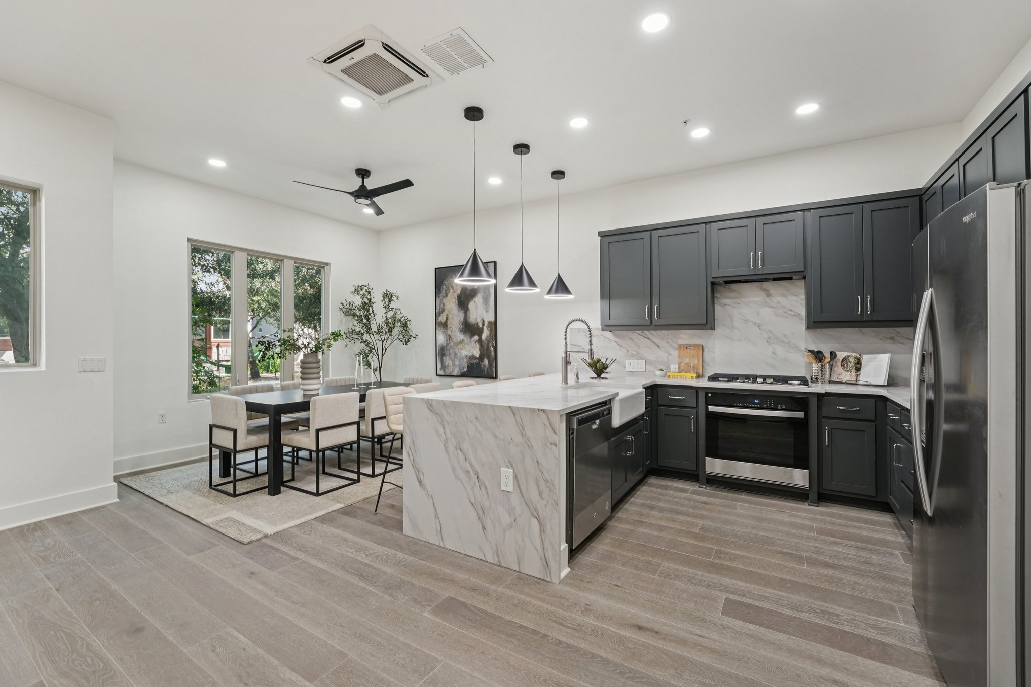 2811 Zach Scott Street Austin, TX 78723 - Photo 12 of 37 Kitchen featuring a peninsula, light stone counters, backsplash, stainless steel appliances, and recessed lighting