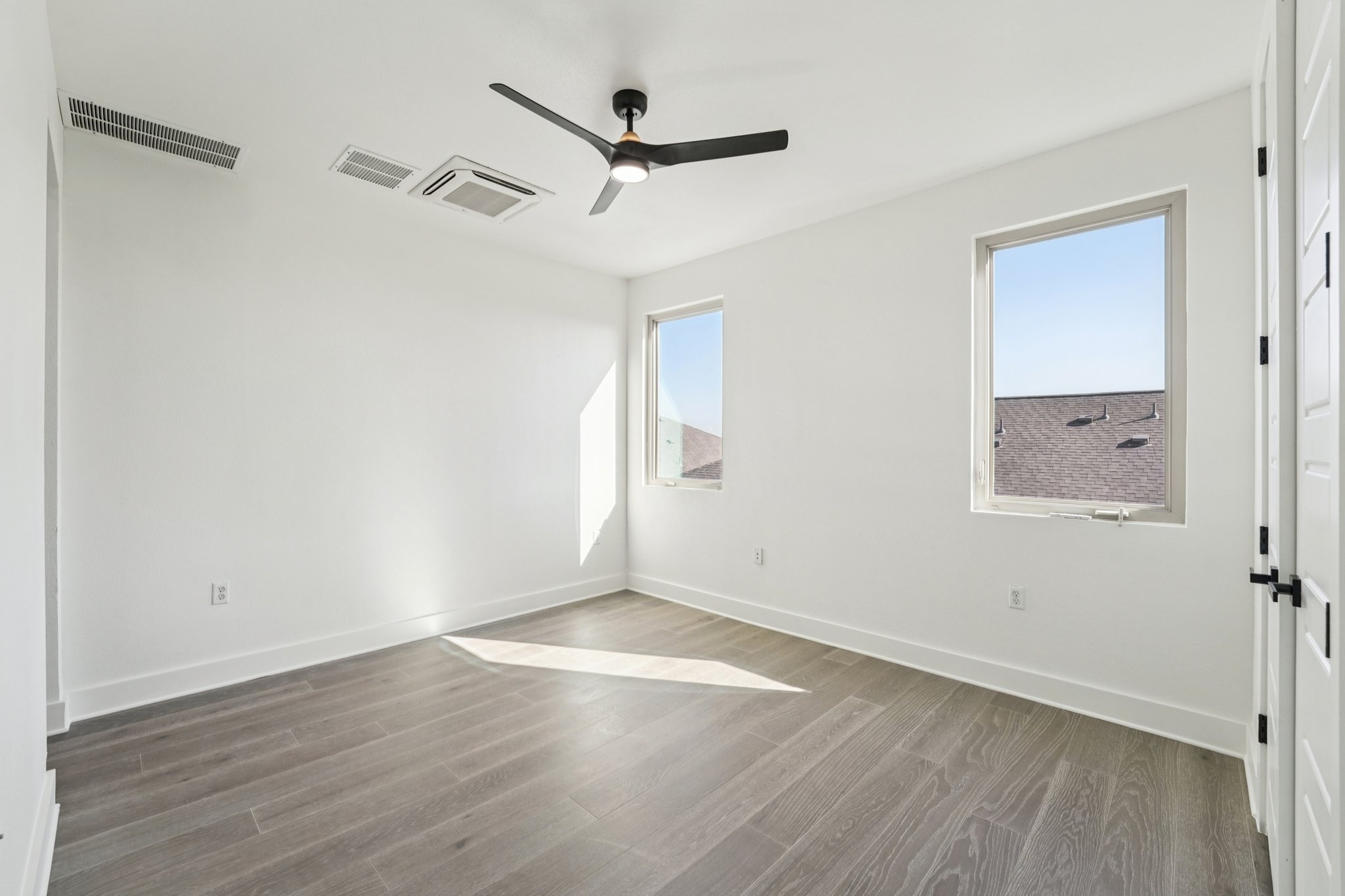 2811 Zach Scott Street Austin, TX 78723 - Photo 27 of 37 Spare room featuring wood finished floors and a ceiling fan