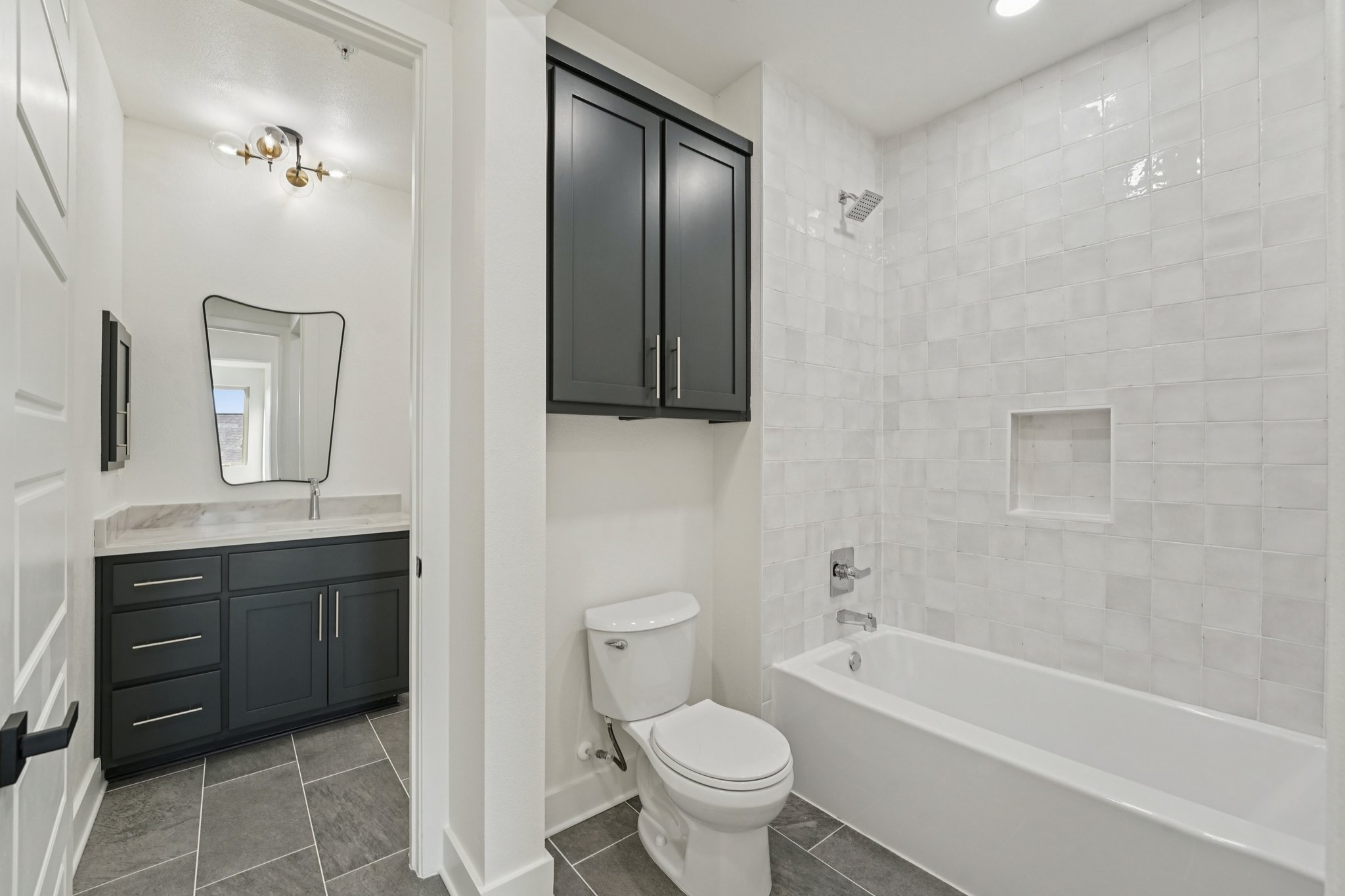 2811 Zach Scott Street Austin, TX 78723 - Photo 30 of 37 Full bathroom with vanity, tub / shower combination, dark tile patterned floors, and recessed lighting