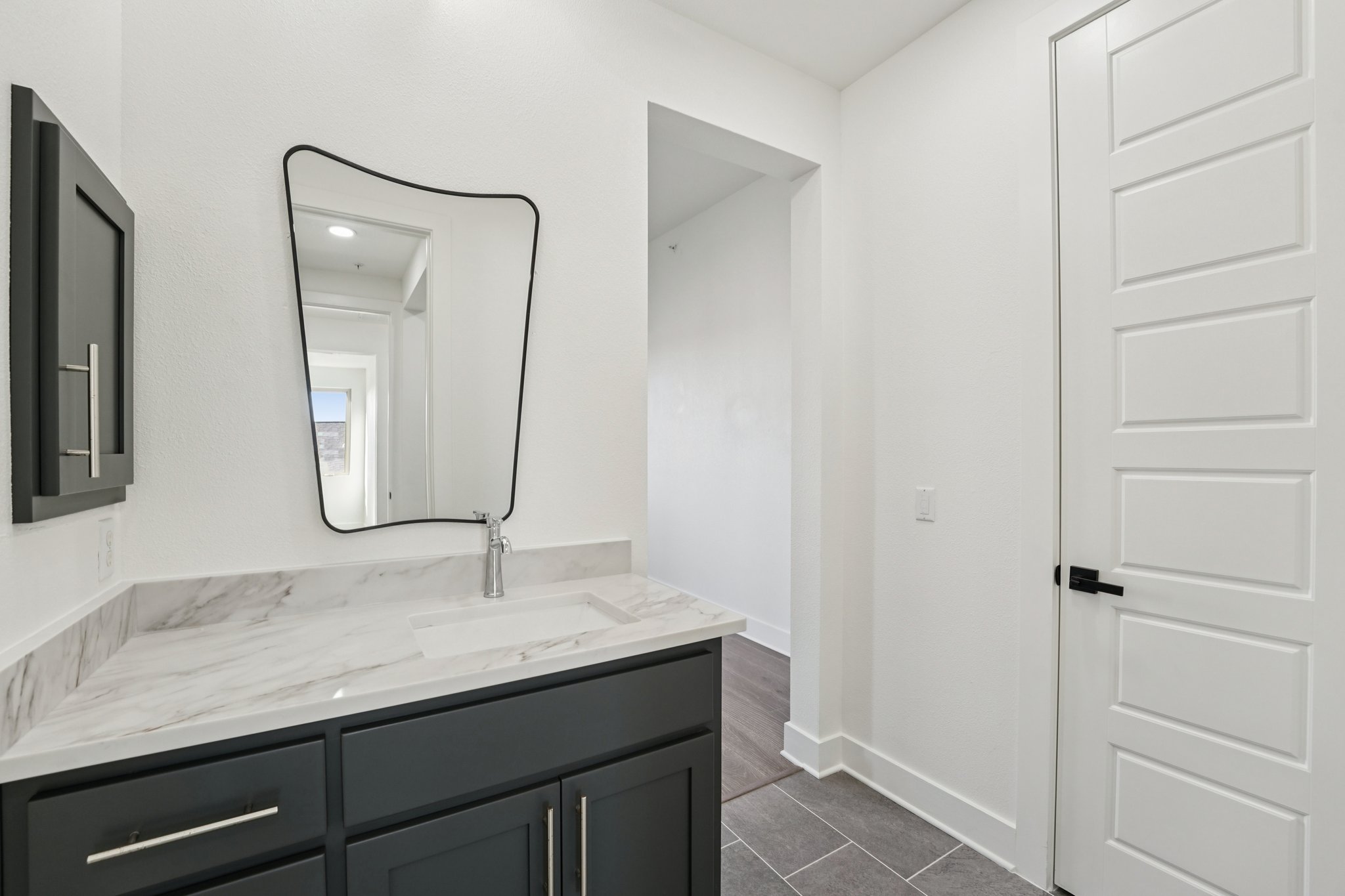 2811 Zach Scott Street Austin, TX 78723 - Photo 32 of 37 Bathroom featuring dark tile patterned floors and vanity