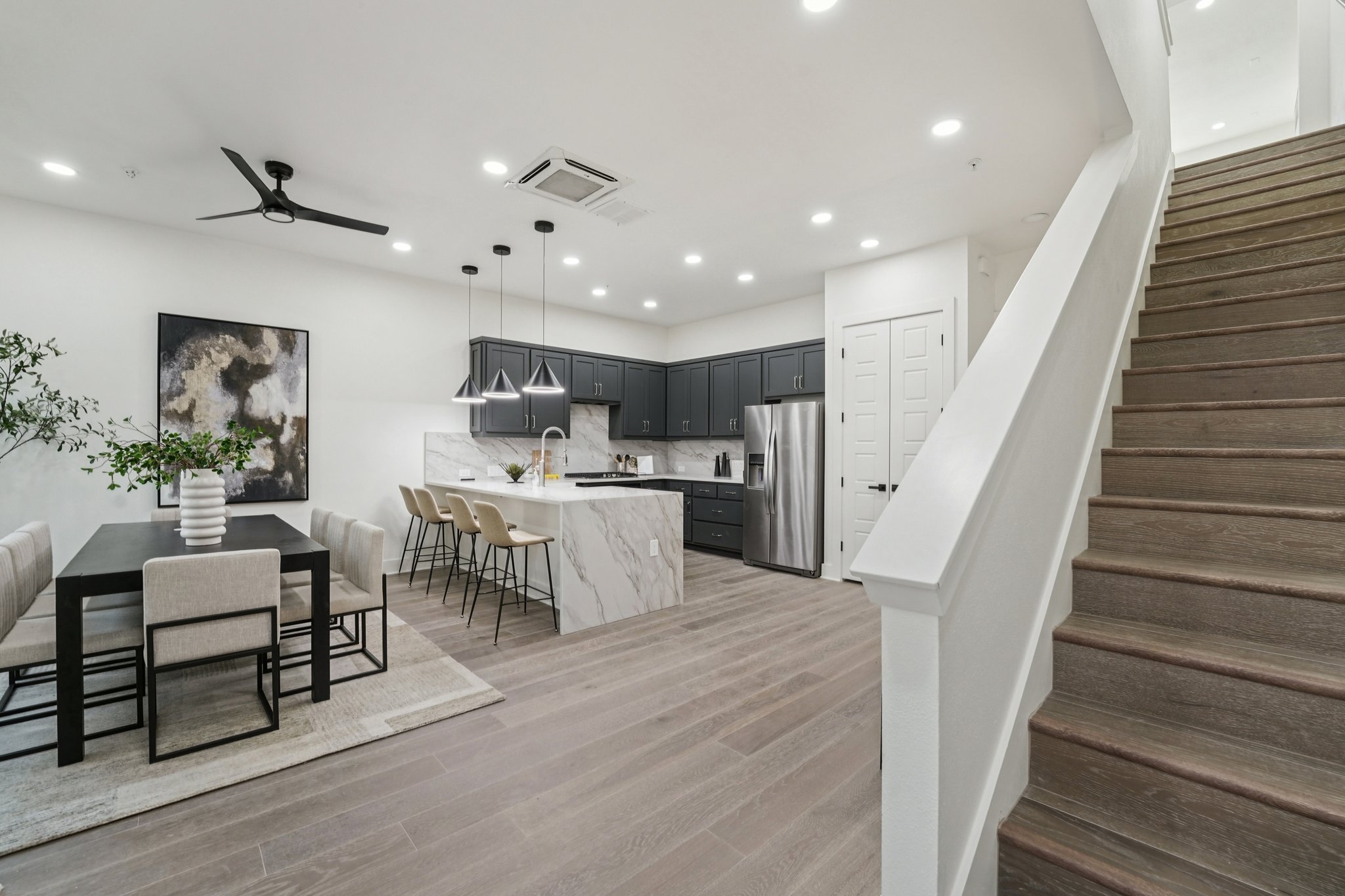 2811 Zach Scott Street Austin, TX 78723 - Photo 6 of 37 Kitchen with decorative backsplash, a peninsula, stainless steel fridge with ice dispenser, recessed lighting, and hanging light fixtures