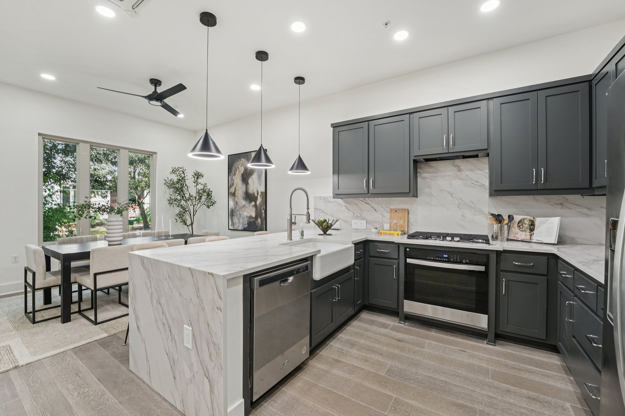 2811 Zach Scott Street Austin, TX 78723 - Photo 10 of 37 Kitchen featuring light stone countertops, a peninsula, appliances with stainless steel finishes, decorative light fixtures, and recessed lighting