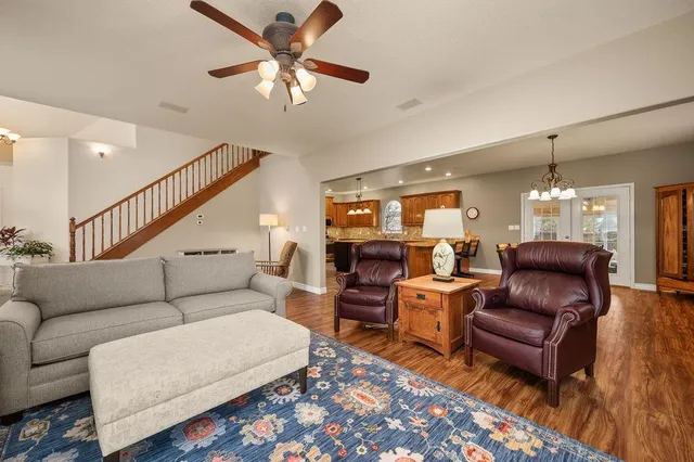 a living room with furniture ceiling fan and a rug