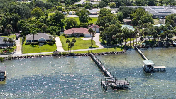 an aerial view of a pool with a yard
