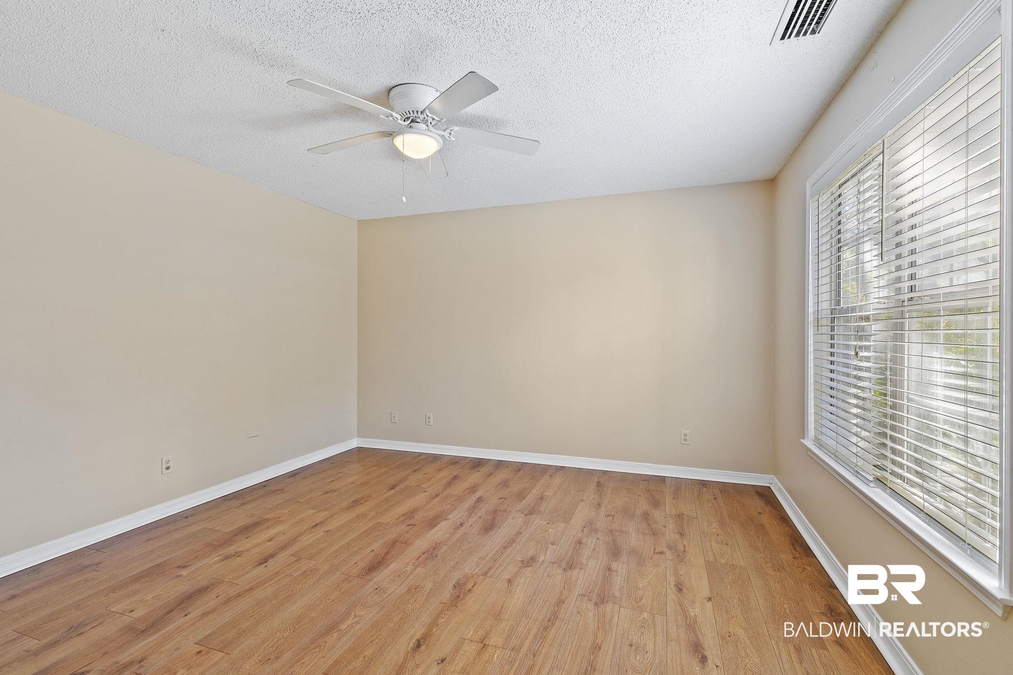 359 Ridgewood Drive Daphne, AL 36526 - Photo 30 of 73 Downstairs Primary Bedroom with LVP flooring and ceiling fan