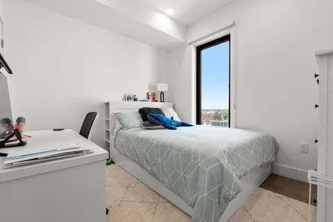 a bedroom with bed and a window