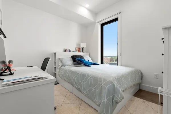 a bedroom with bed and a window