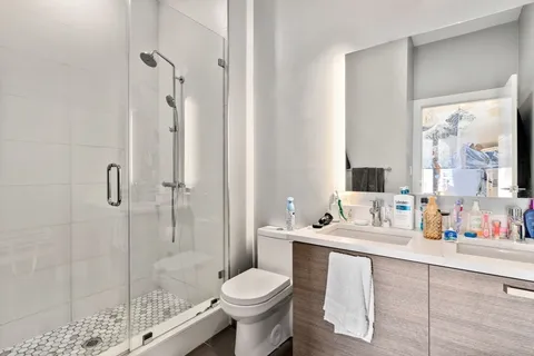 a bathroom with a sink toilet and shower