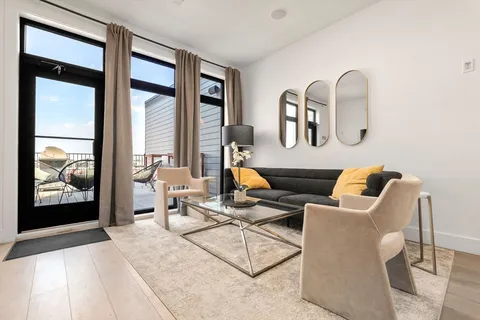 a living room filled with furniture and large window