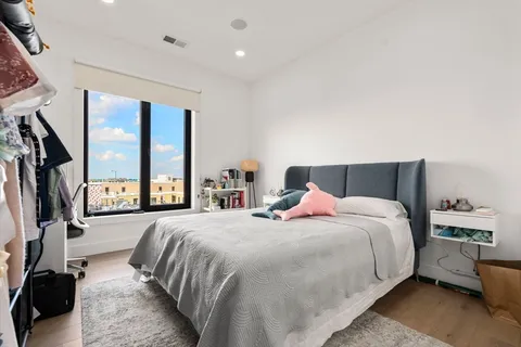 a bedroom with a large bed and a large window