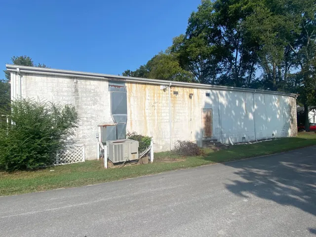 a white house with a tree in front of it