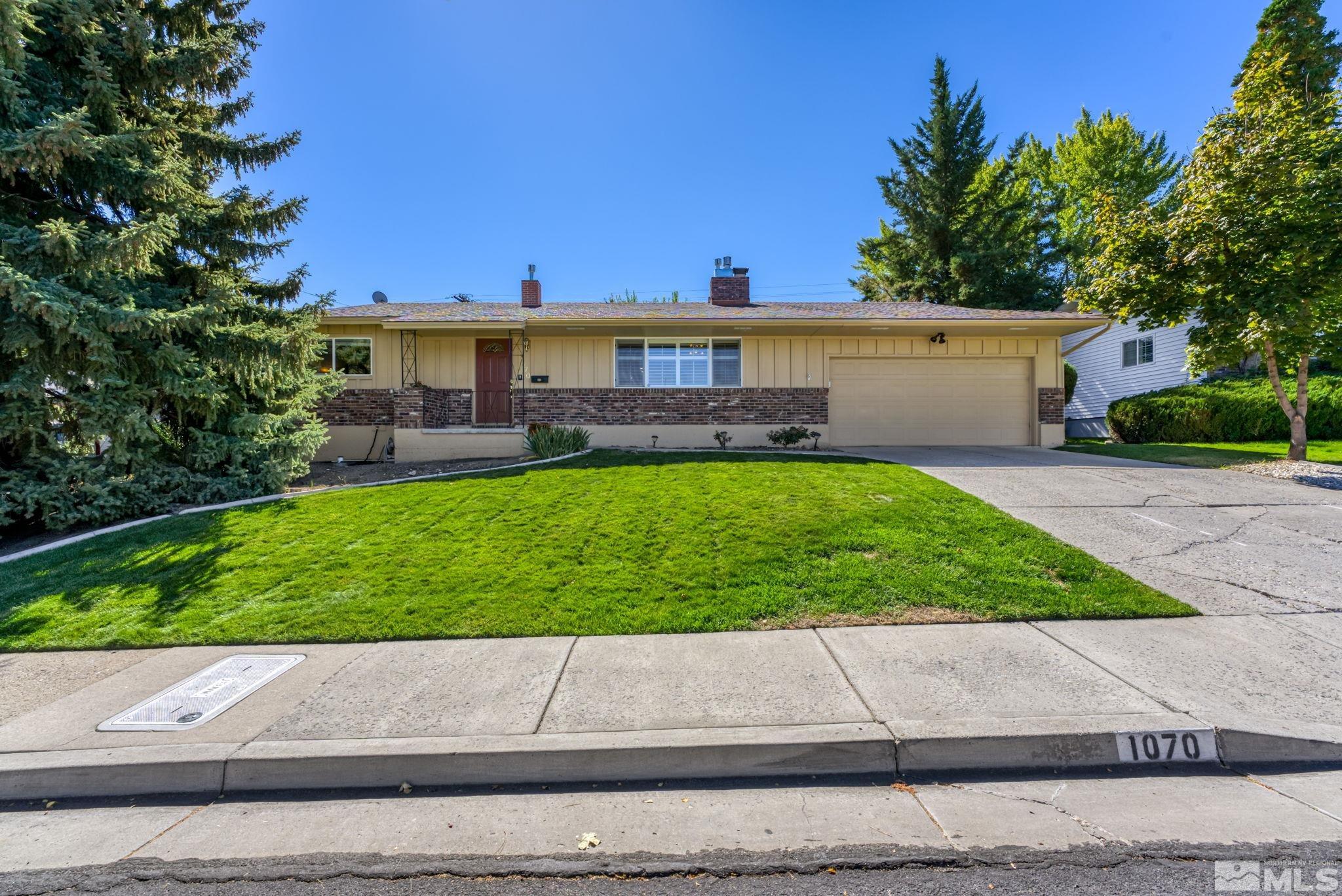 a view of a house with a yard and a pathway