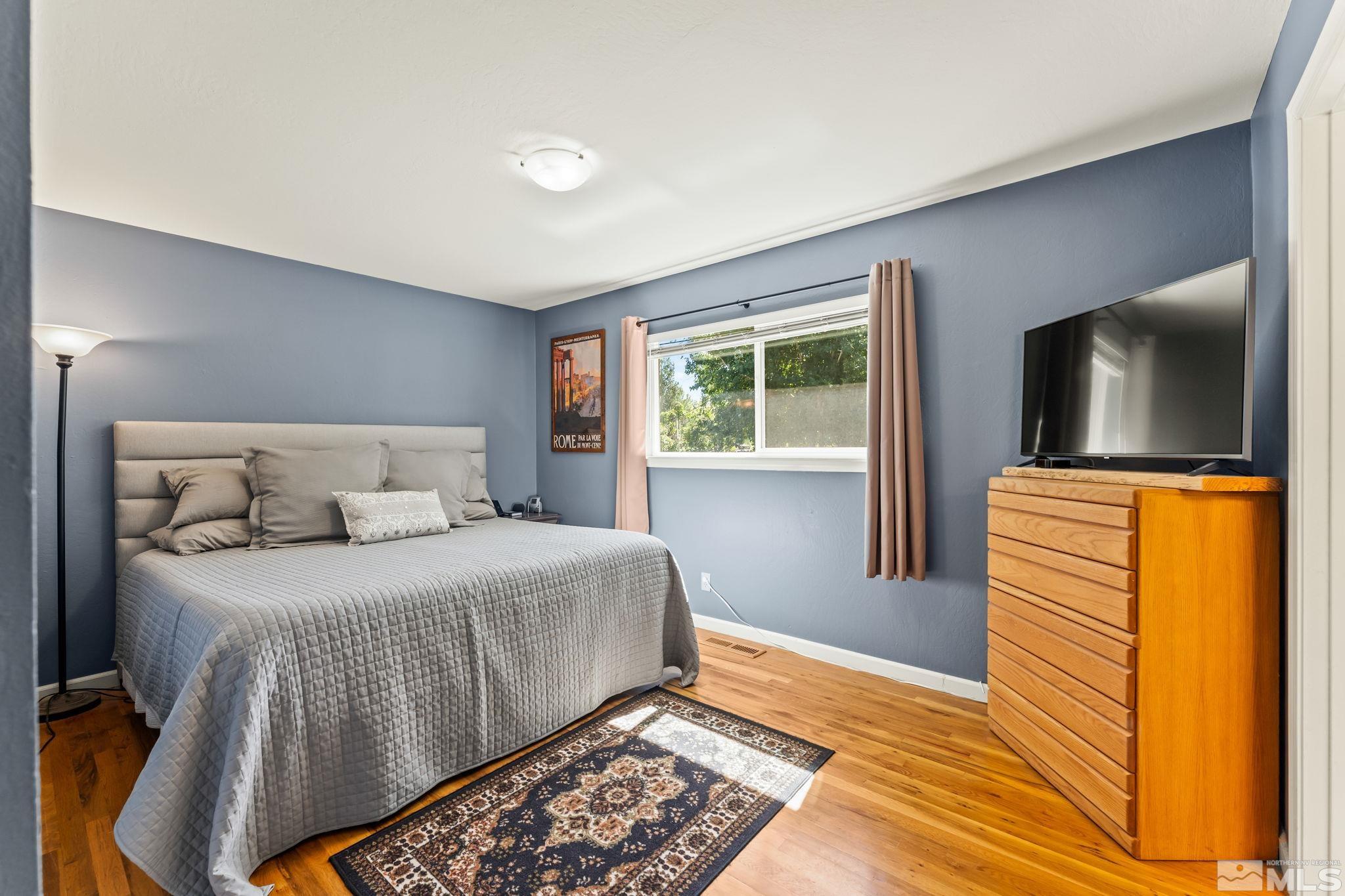 1070 Pineridge Drive Reno, NV 89509 - Photo 13 of 24 a bedroom with a bed and a flat screen tv