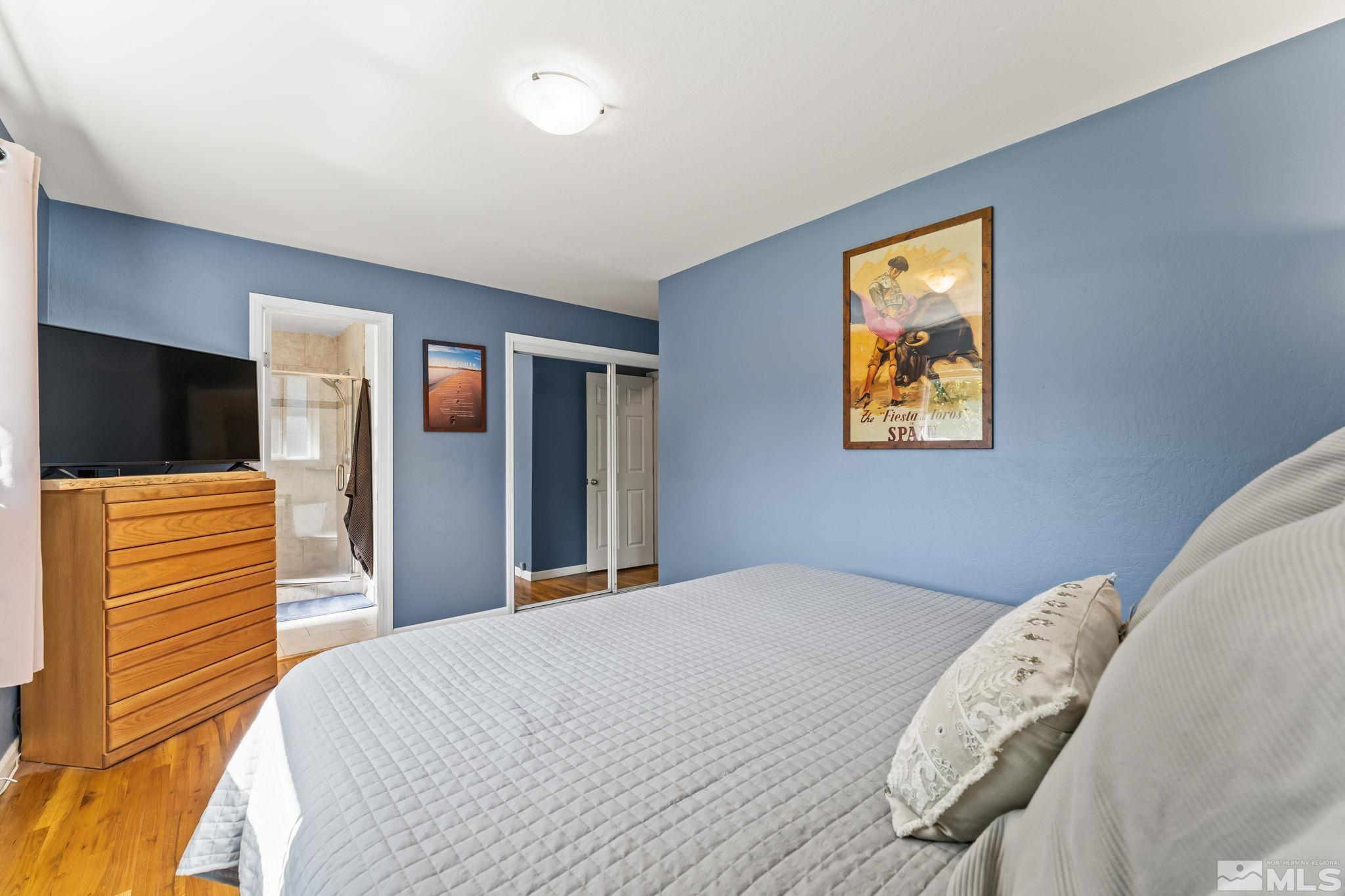 1070 Pineridge Drive Reno, NV 89509 - Photo 14 of 24 a bedroom with a bed and a flat screen tv