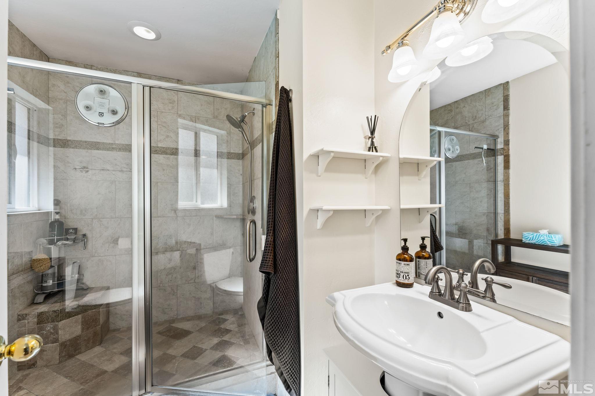 1070 Pineridge Drive Reno, NV 89509 - Photo 15 of 24 a bathroom with a sink shower and a mirror