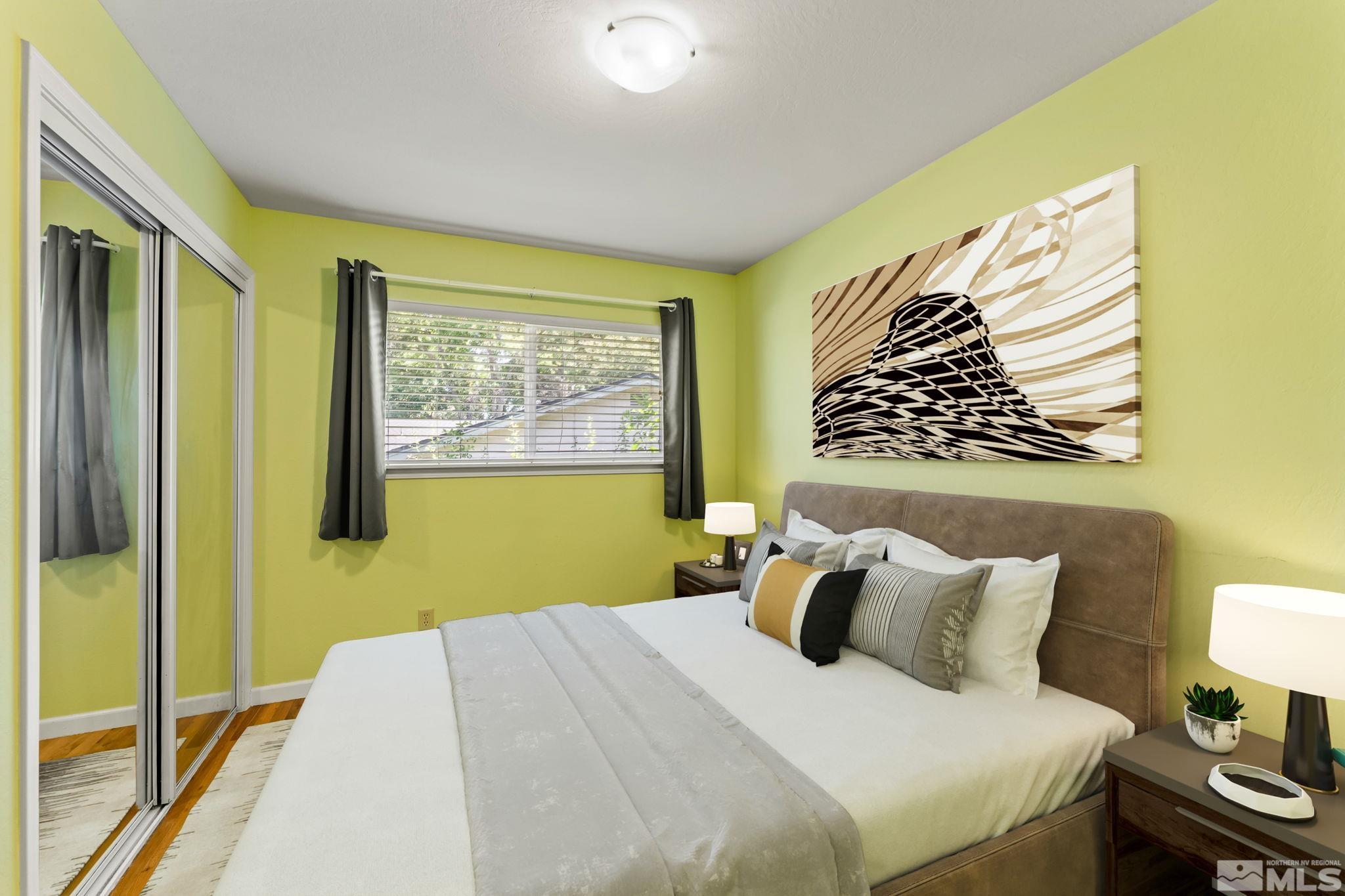 1070 Pineridge Drive Reno, NV 89509 - Photo 16 of 24 a bedroom with a bed and wooden floor