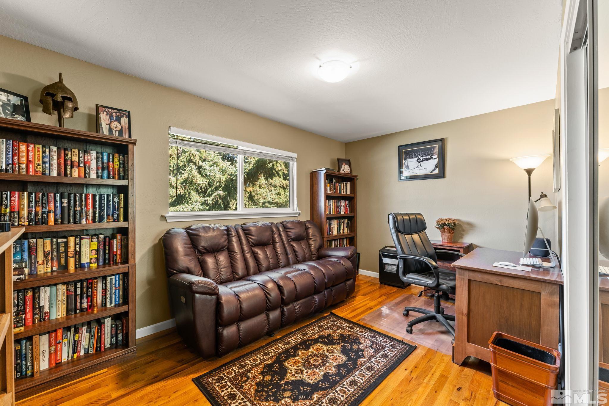 1070 Pineridge Drive Reno, NV 89509 - Photo 17 of 24 a living room with a couch and a book shelf