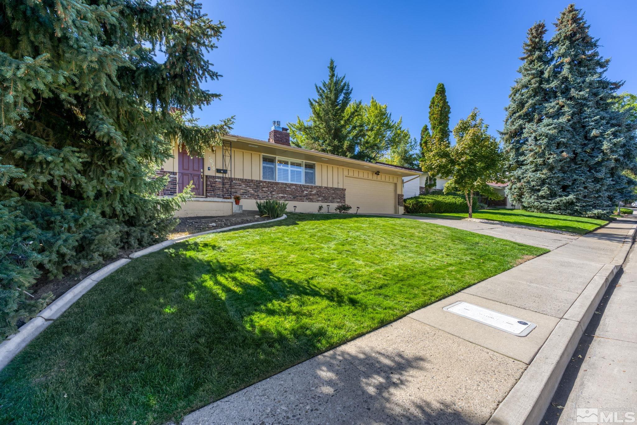 1070 Pineridge Drive Reno, NV 89509 - Photo 2 of 24 a view of a house with a yard and a tree