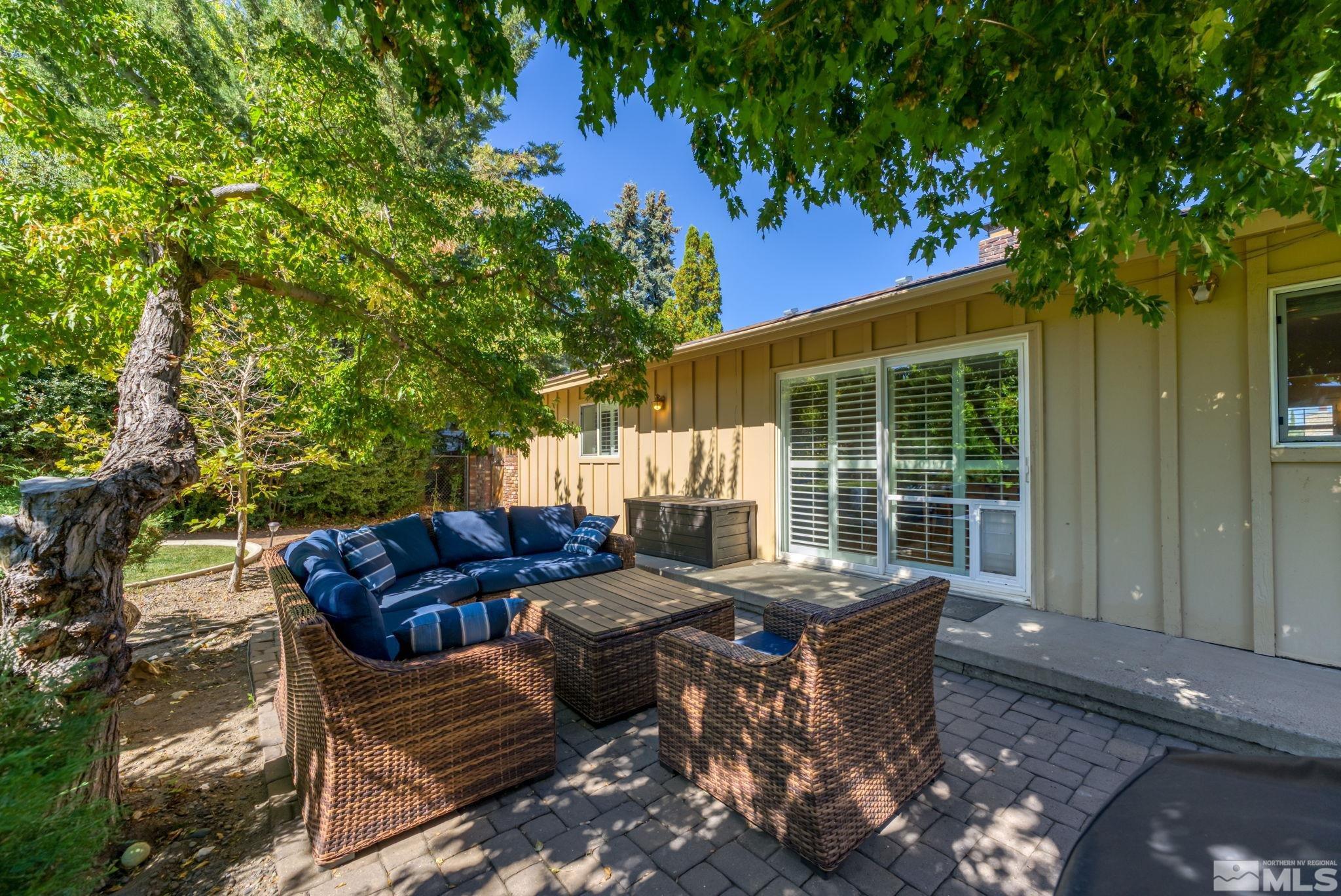 1070 Pineridge Drive Reno, NV 89509 - Photo 21 of 24 a view of backyard with outdoor seating and trees