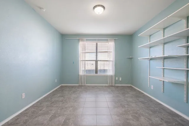 a view of an empty room with a closet