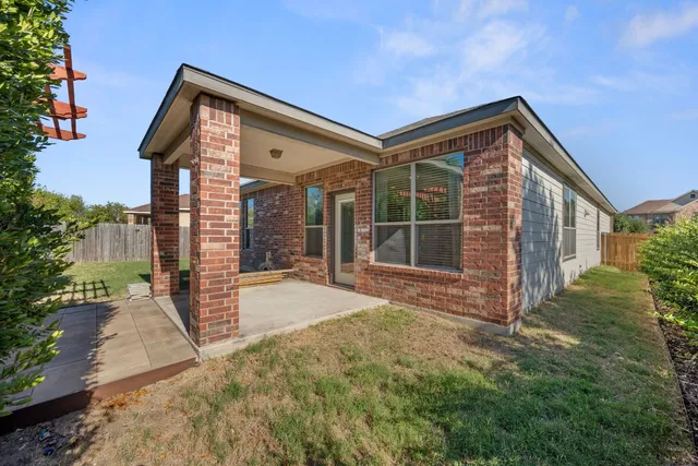 a view of a house with backyard and porch