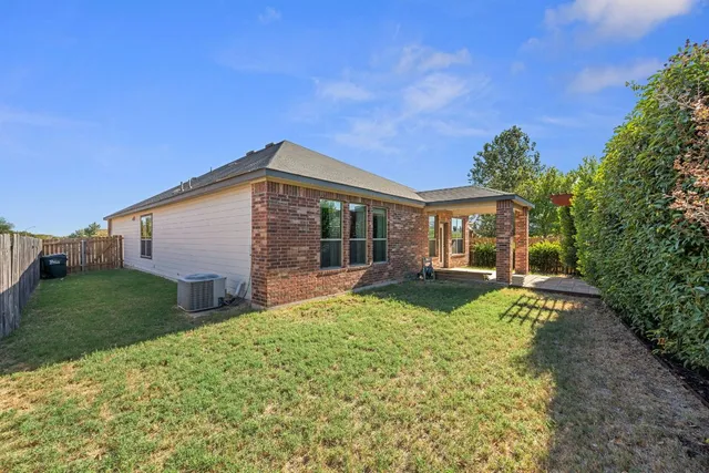 a backyard of a house with basket ball court and outdoor seating
