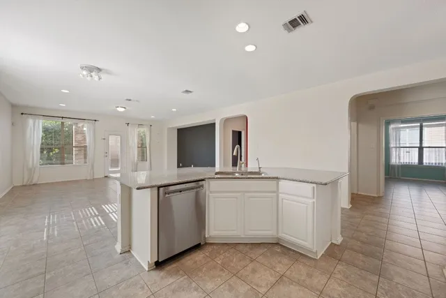 a kitchen with stainless steel appliances a sink and cabinets