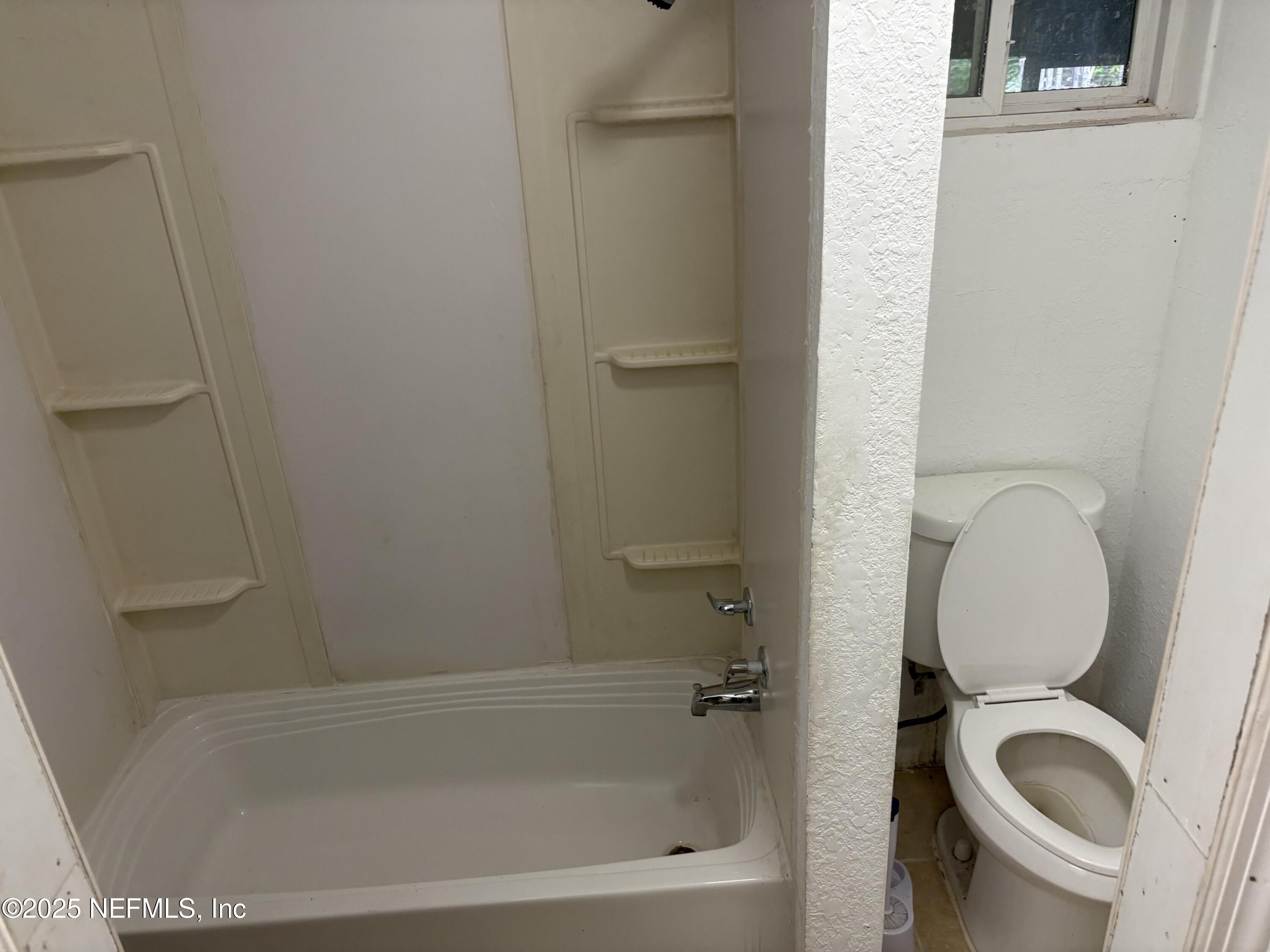 271 Heidt Road Palatka, FL 32177 - Photo 12 of 21 a bathroom with a granite countertop bathtub shower and toilet