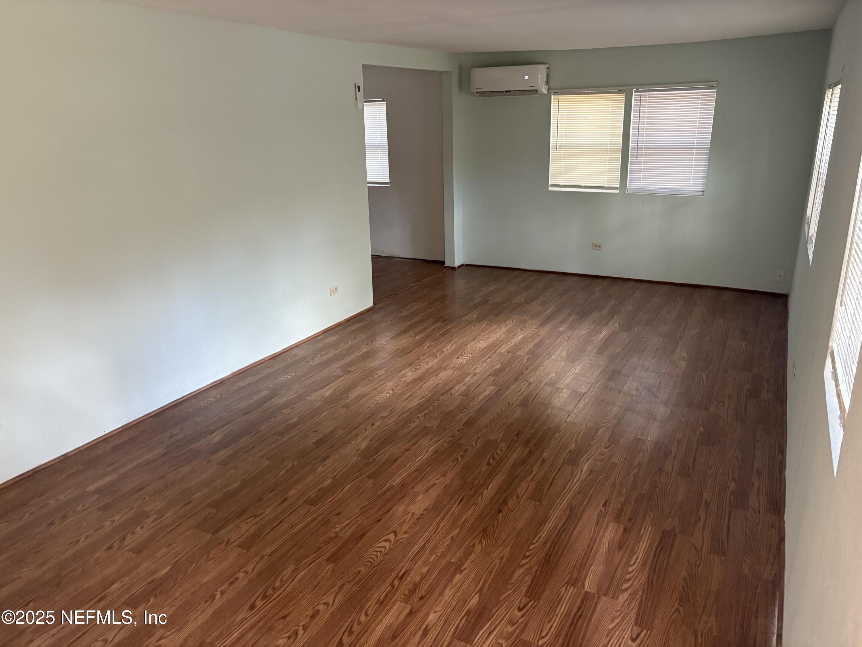 271 Heidt Road Palatka, FL 32177 - Photo 5 of 21 an empty room with wooden floor and windows