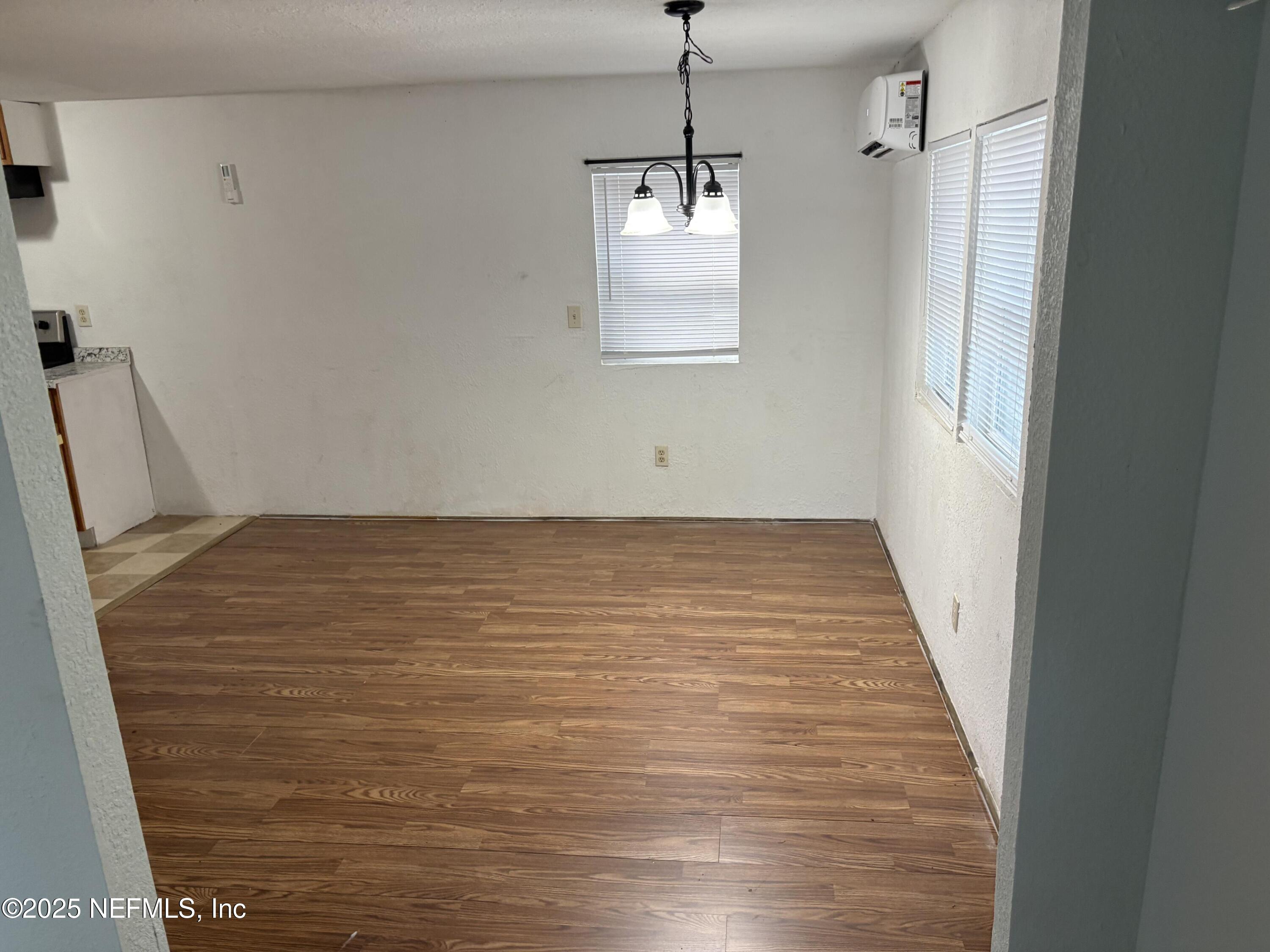 271 Heidt Road Palatka, FL 32177 - Photo 6 of 21 a view of an empty room with wooden floor and a window