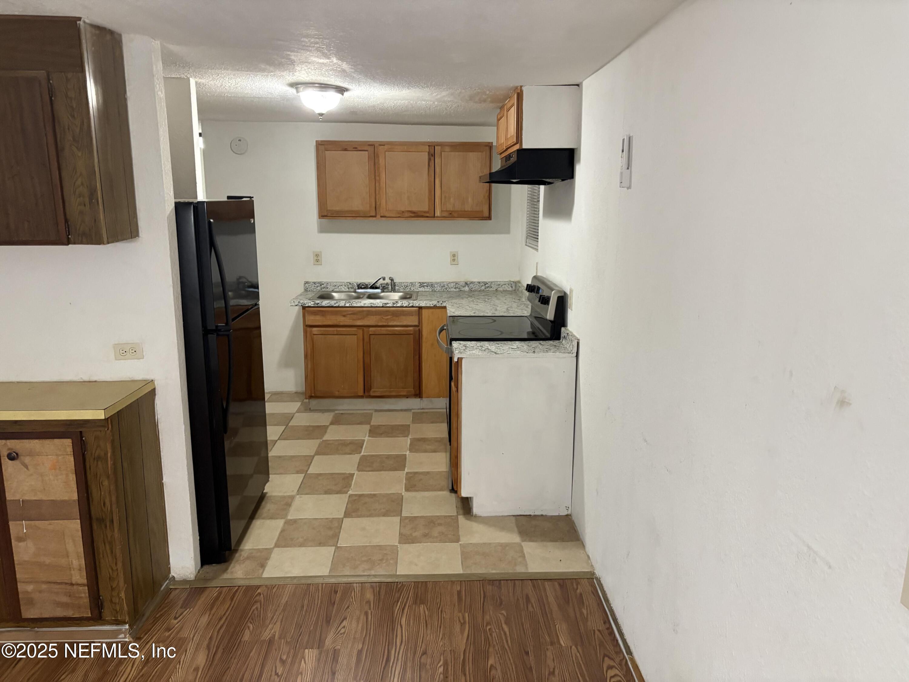 271 Heidt Road Palatka, FL 32177 - Photo 8 of 21 a kitchen with a sink a refrigerator a counter top space and cabinets