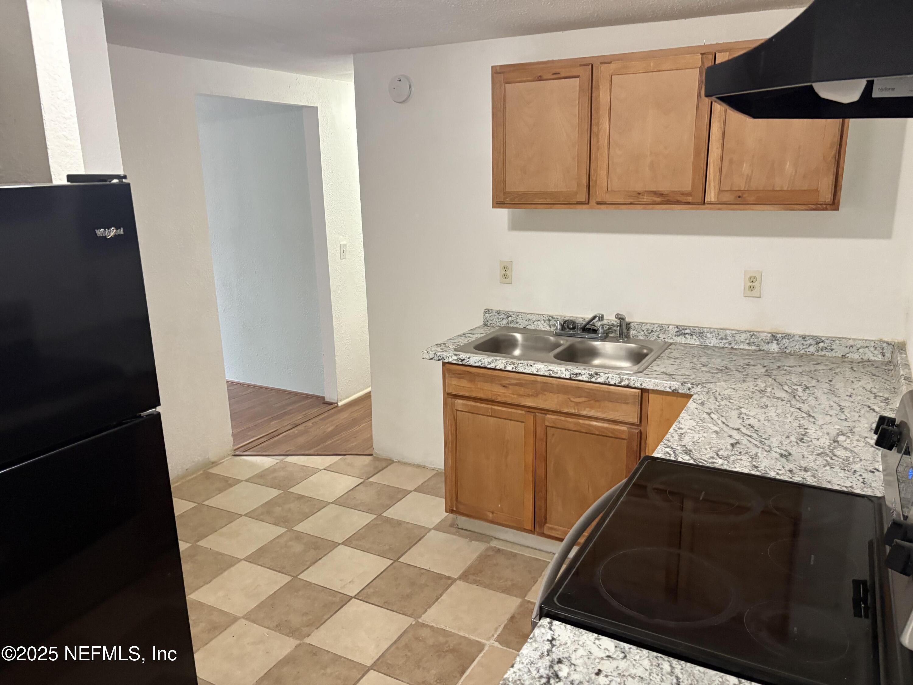 271 Heidt Road Palatka, FL 32177 - Photo 9 of 21 a kitchen with granite countertop a sink stove and cabinets