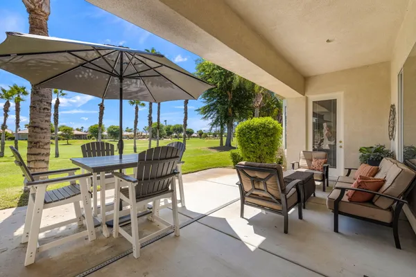 a patio with a patio table and chairs