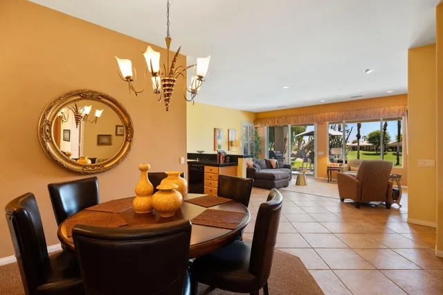 a dining room with furniture and a chandelier