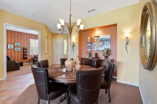 a dining room with furniture a chandelier and window